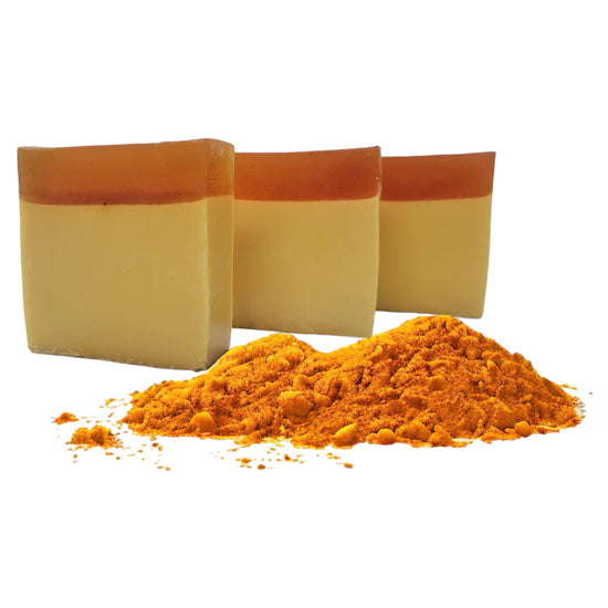 Turmeric Brightening soap bar with turmeric powder in background