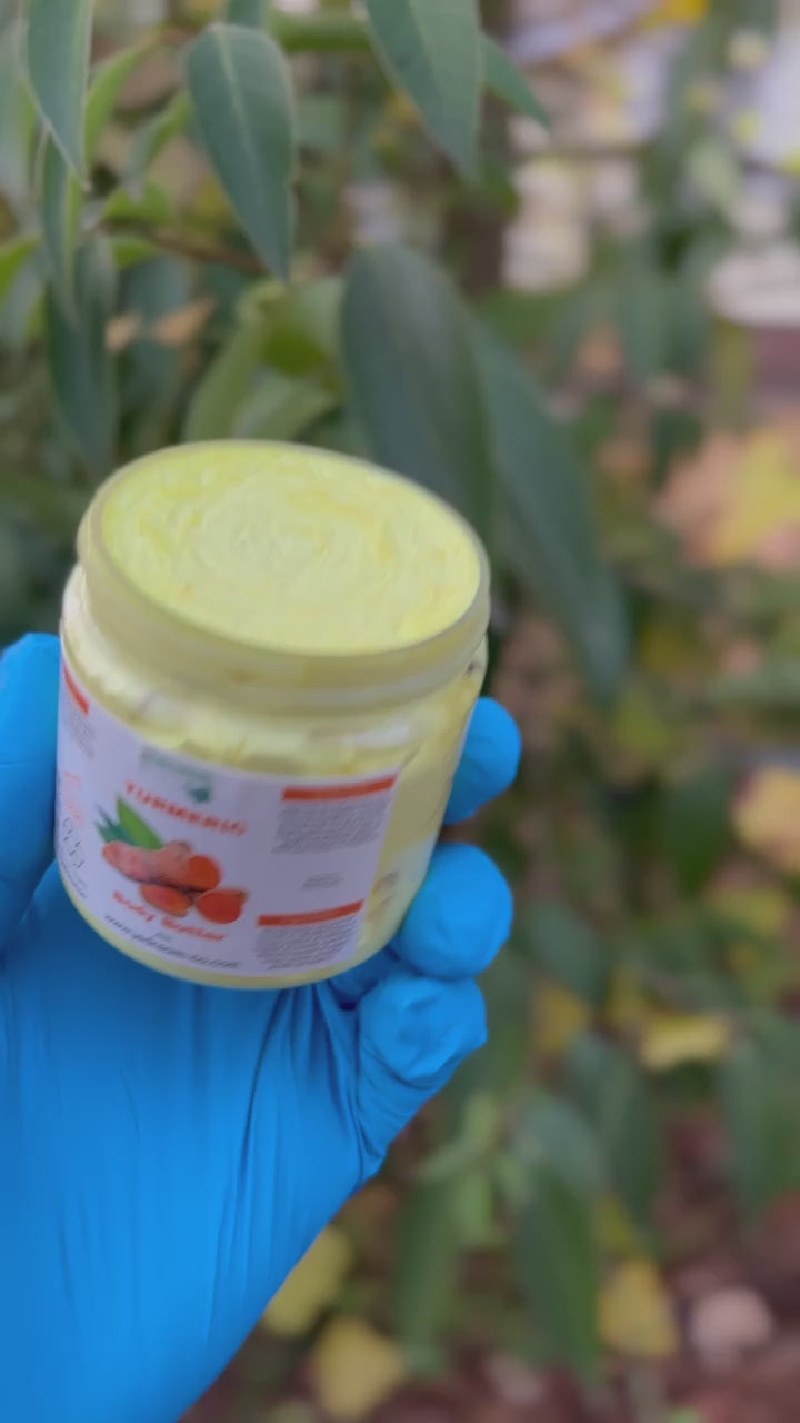 Holding turmeric body butter out in nature 